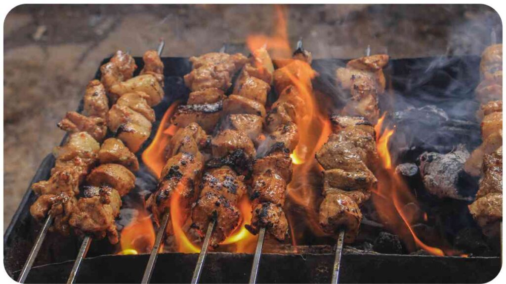 chicken kebabs are being cooked on a grill