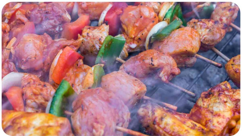 chicken kebabs are being cooked on a grill